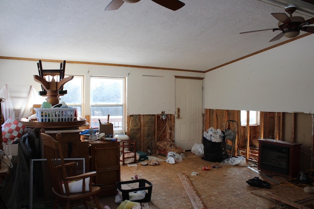 miscellaneous room with ceiling fan, crown molding, and a textured ceiling