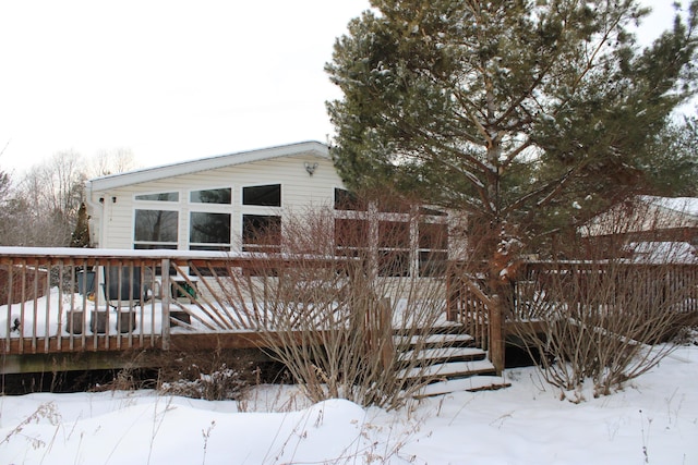 snow covered property featuring a deck