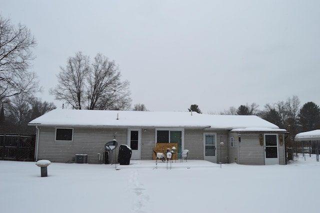 snow covered property featuring central air condition unit