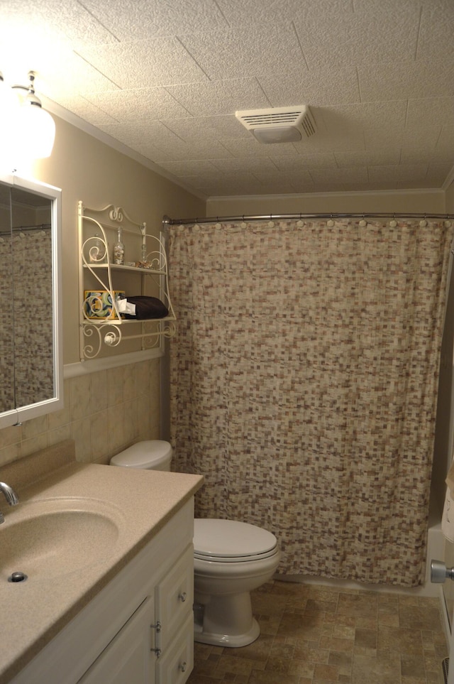 full bathroom with toilet, crown molding, tile walls, vanity, and shower / bath combo with shower curtain