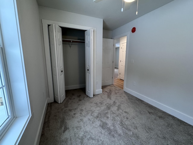 unfurnished bedroom with light colored carpet and a closet