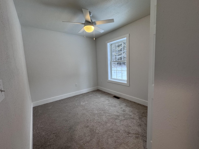 carpeted empty room with a textured ceiling and ceiling fan