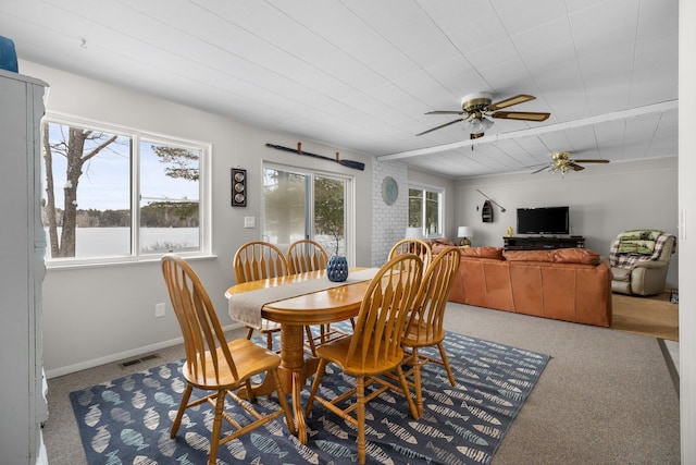 dining area featuring carpet floors and ceiling fan