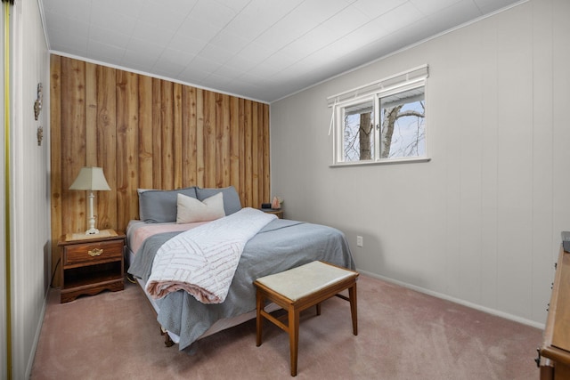 carpeted bedroom featuring wood walls