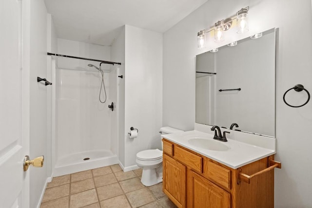 bathroom featuring tile patterned flooring, vanity, toilet, and walk in shower