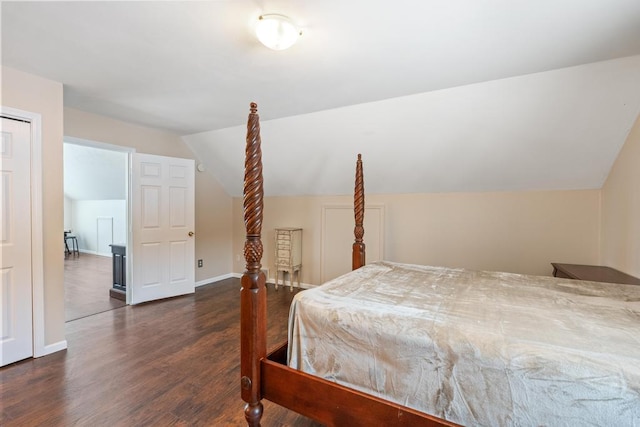 bedroom featuring dark hardwood / wood-style flooring and vaulted ceiling