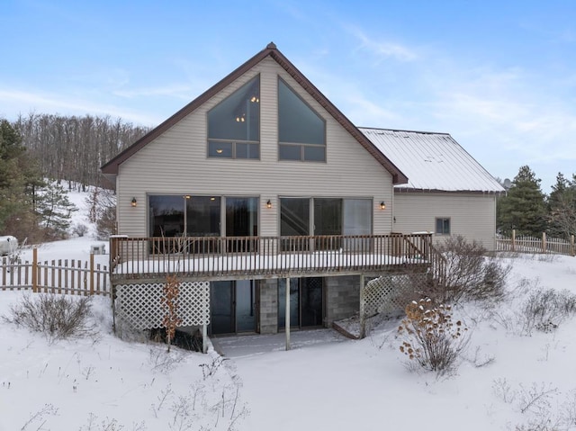 snow covered property with a deck