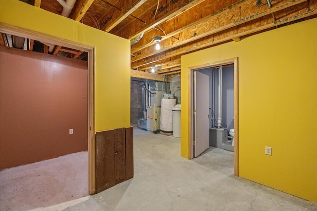 basement featuring water heater and heating unit