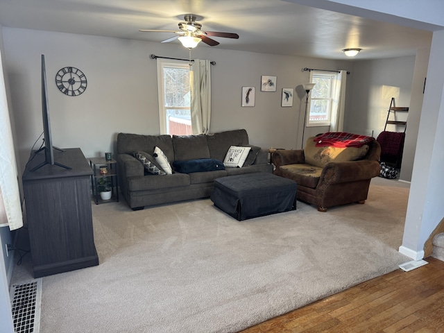 living room featuring a healthy amount of sunlight, hardwood / wood-style floors, and ceiling fan