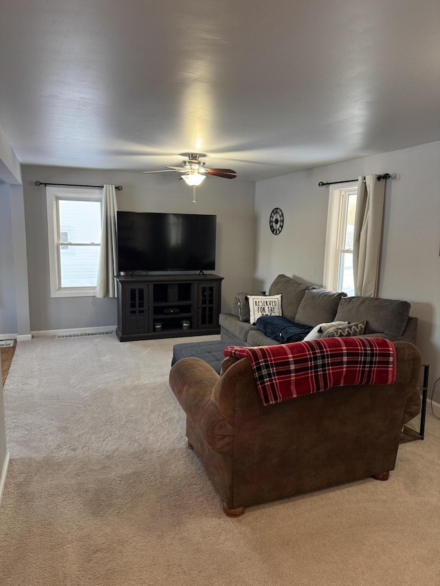 carpeted living room with ceiling fan and plenty of natural light