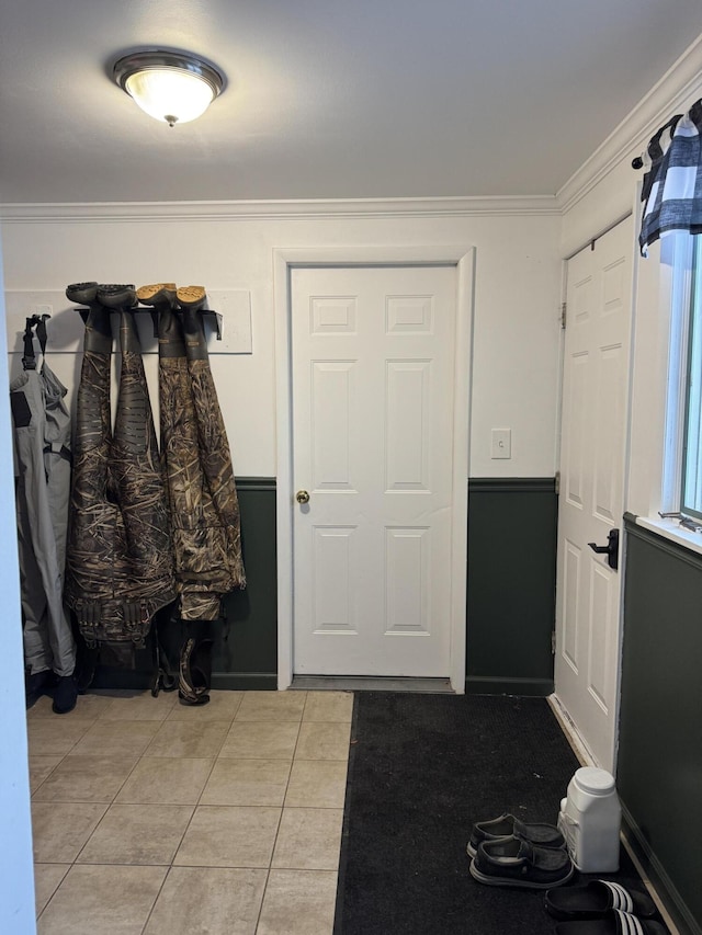 mudroom with light tile patterned floors and ornamental molding