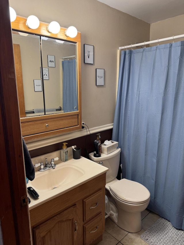 bathroom featuring tile patterned floors, toilet, a shower with shower curtain, and vanity