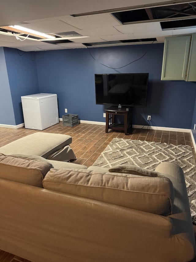 living room featuring a paneled ceiling