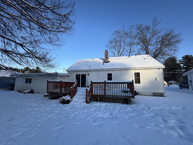 snow covered property featuring a deck