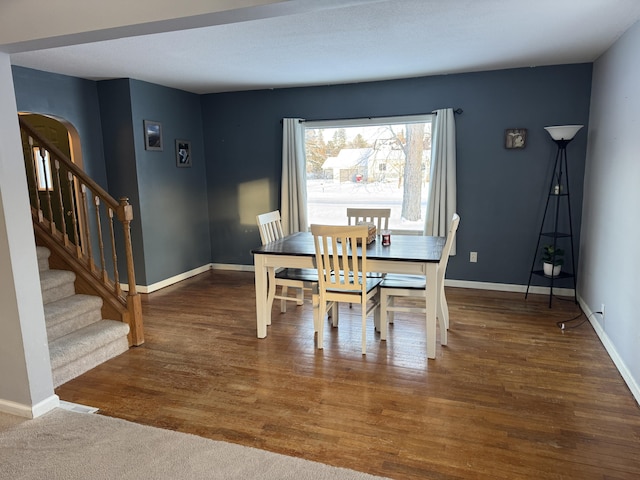 dining space with dark hardwood / wood-style floors