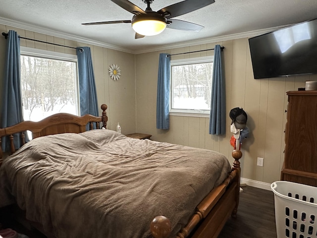 bedroom featuring crown molding, dark hardwood / wood-style floors, ceiling fan, and a textured ceiling