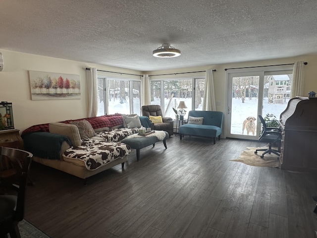 living room featuring plenty of natural light, dark hardwood / wood-style flooring, and a textured ceiling