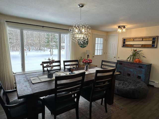 dining room with an inviting chandelier, a baseboard radiator, hardwood / wood-style floors, and a textured ceiling