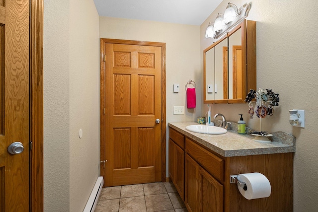 bathroom with baseboard heating, vanity, and tile patterned flooring