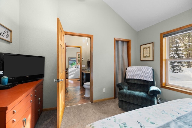 carpeted bedroom featuring lofted ceiling and ensuite bath