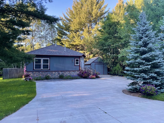 view of property exterior featuring a yard and a storage unit