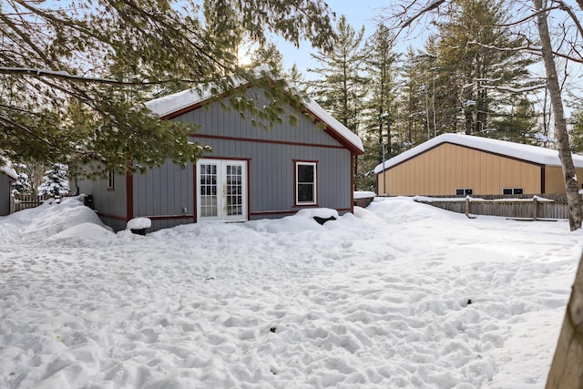 snow covered house with french doors