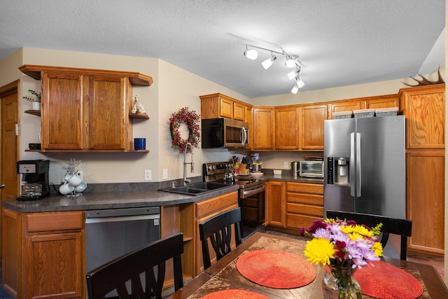 kitchen with appliances with stainless steel finishes and a textured ceiling