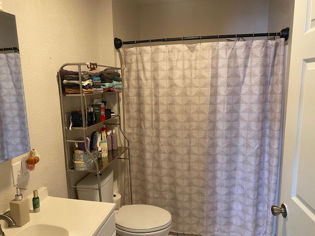 bathroom featuring vanity and toilet