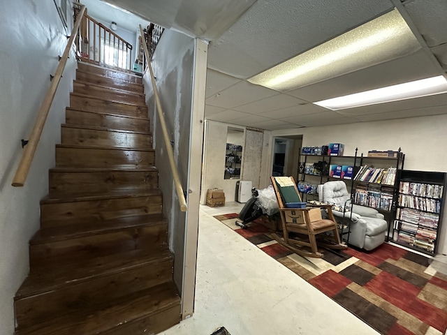 staircase featuring hardwood / wood-style flooring and a paneled ceiling