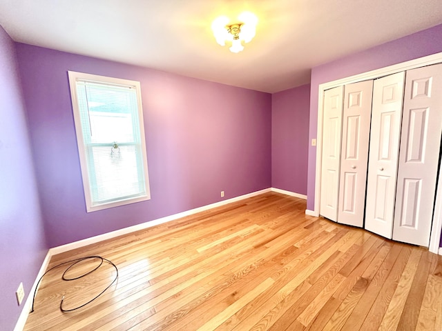 unfurnished bedroom featuring a closet and light hardwood / wood-style flooring