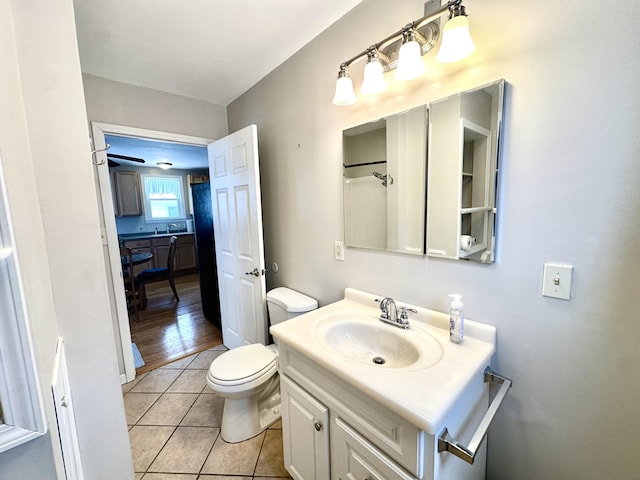 bathroom with vanity, tile patterned floors, and toilet