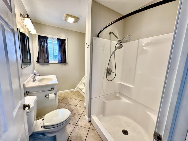 bathroom featuring vanity, a shower, tile patterned floors, and toilet