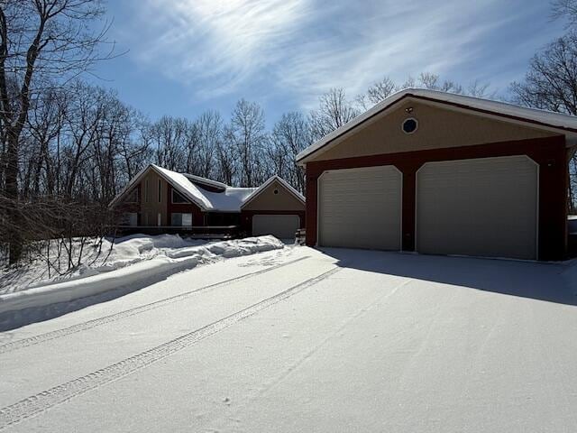 view of front of house with a garage and an outbuilding