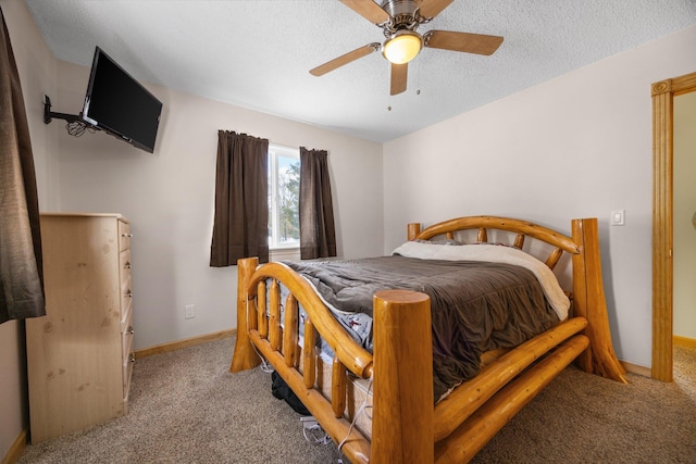 bedroom with ceiling fan, light carpet, and a textured ceiling