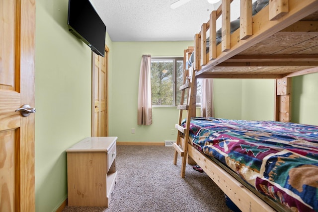 carpeted bedroom featuring a textured ceiling