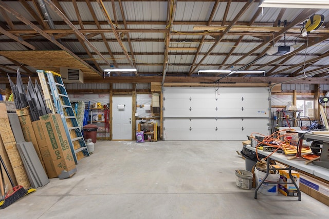 garage with a garage door opener and a workshop area