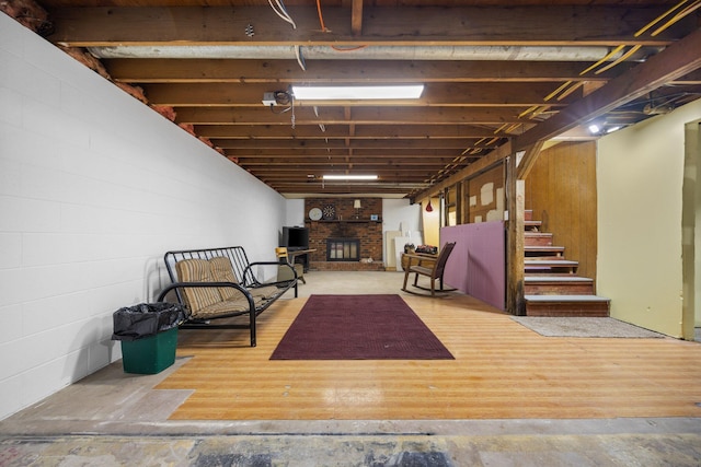 basement with hardwood / wood-style flooring and a fireplace