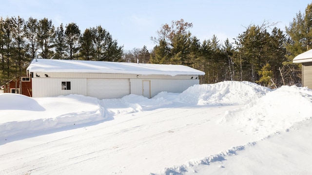 exterior space with a garage and an outdoor structure