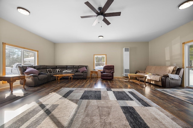 living room featuring dark hardwood / wood-style floors and ceiling fan