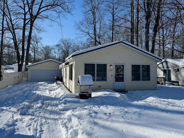 single story home featuring a garage and an outbuilding