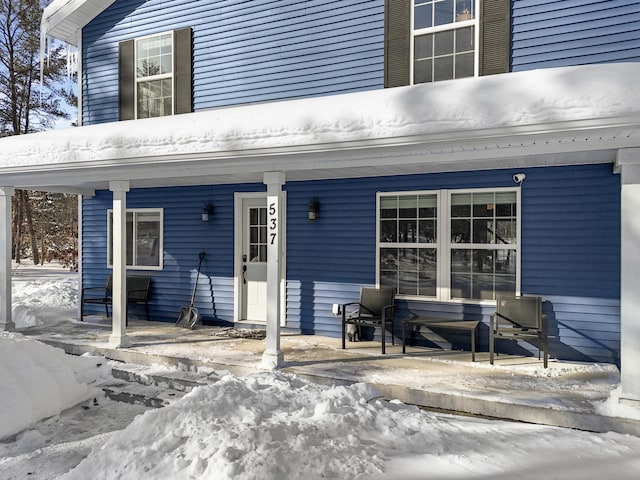 view of snow covered property entrance