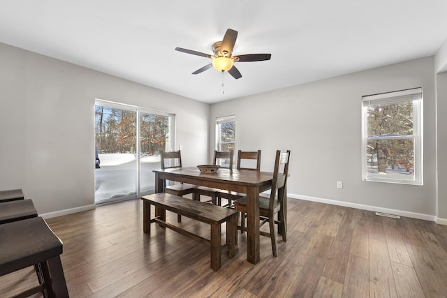 dining space with ceiling fan and dark hardwood / wood-style floors