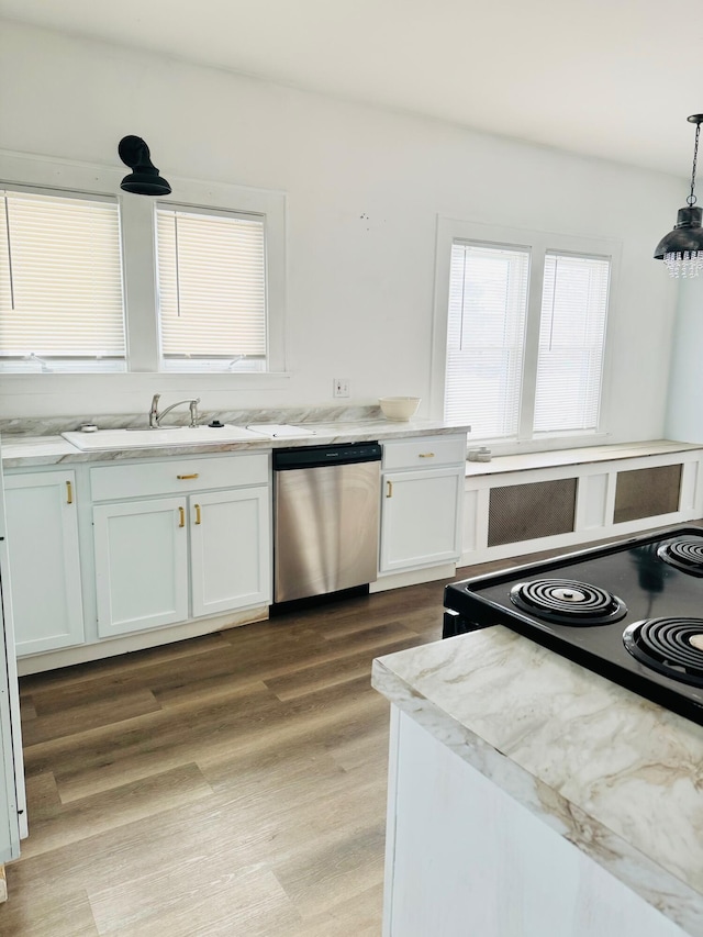 kitchen featuring sink, light hardwood / wood-style flooring, dishwasher, white cabinetry, and hanging light fixtures