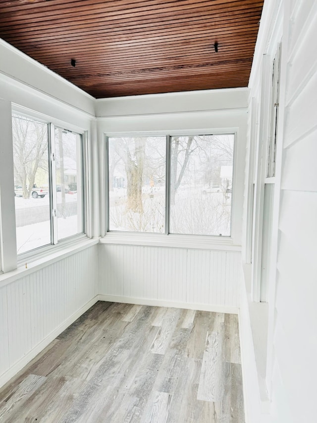 unfurnished sunroom with wood ceiling