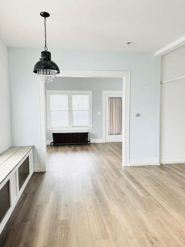 interior space featuring radiator heating unit and wood-type flooring