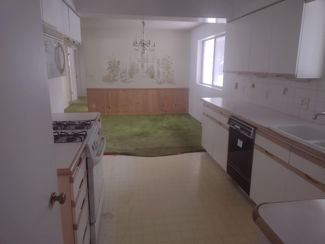 kitchen featuring sink, tasteful backsplash, hanging light fixtures, white appliances, and white cabinets