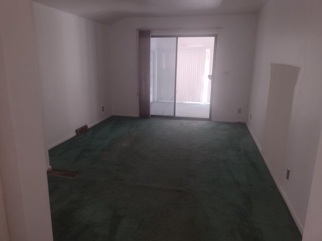 empty room with dark carpet