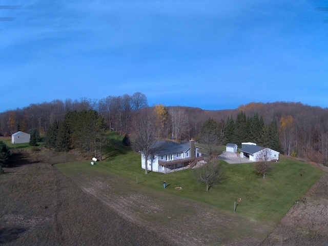 drone / aerial view with a wooded view