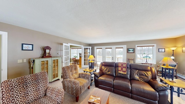 living room featuring carpet floors, a textured ceiling, and french doors