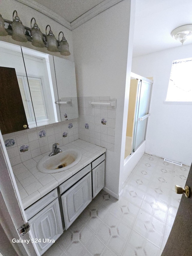 bathroom with vanity and ornamental molding